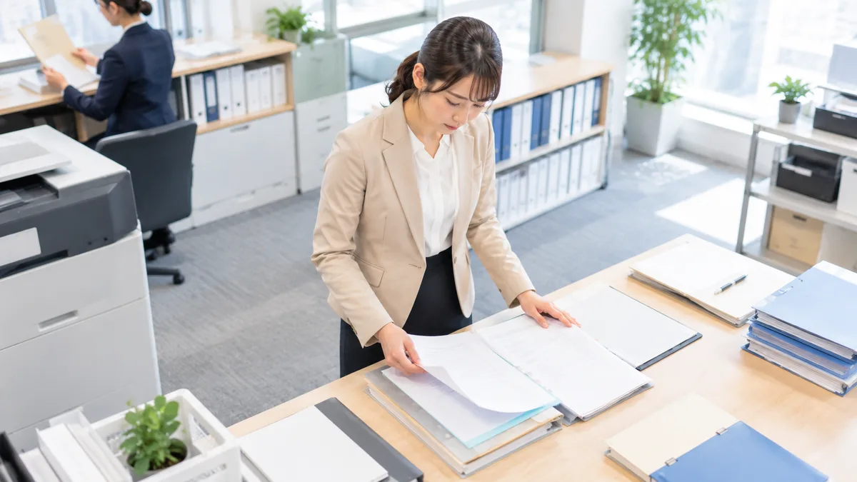 担当業務が変更された理由や現在の仕事の状況を確認し、評価が下がったのか冷静に整理している職場の女性